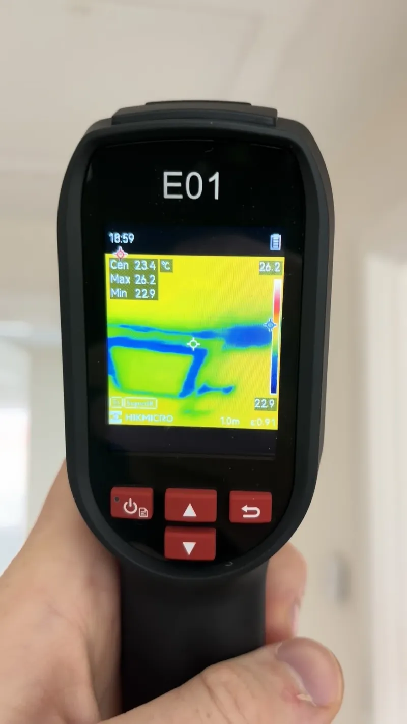 Thermal imaging camera showing a cold outline around a loft hatch where warm air is escaping into the roof void